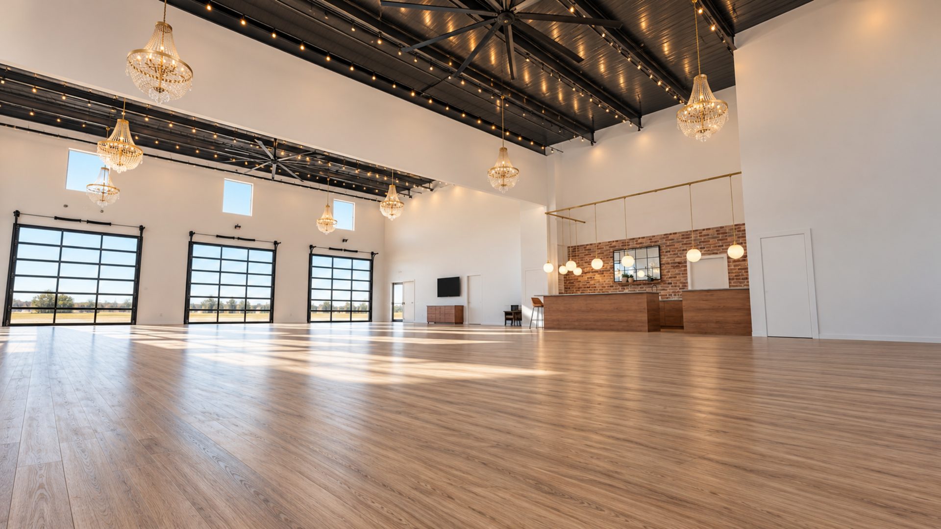 Artist rendering of a bright event hall with large windows, a polished wood floor and a bar