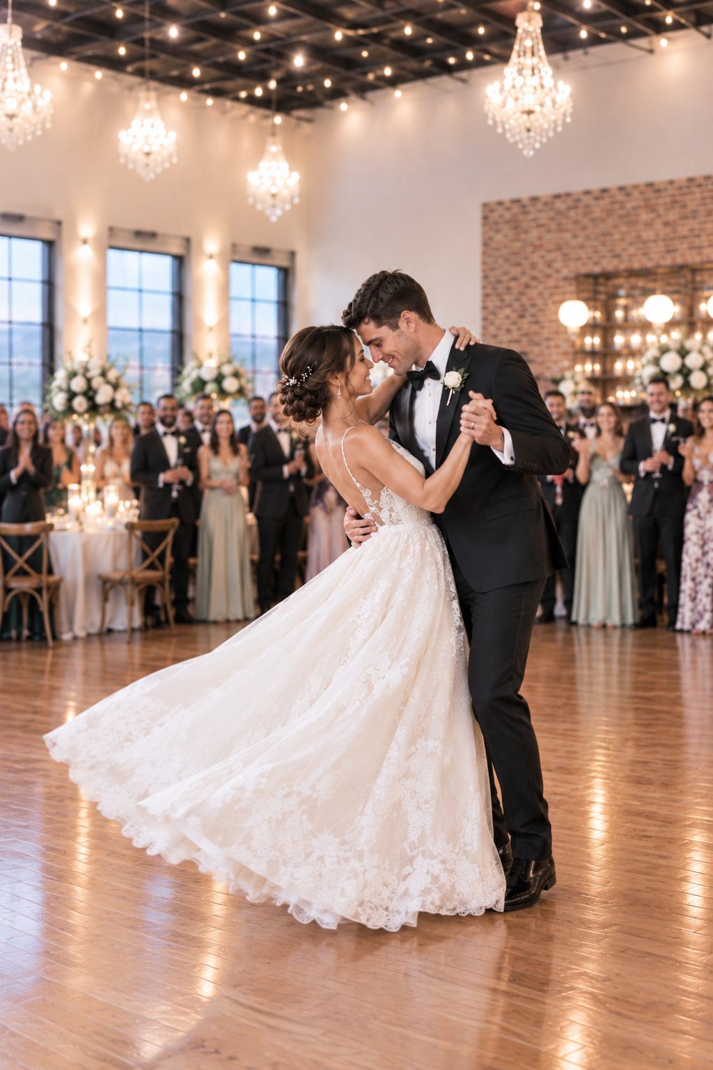 Artist rendering of a bride's flowing gown as she dances with the groom beneath chandeliers and warm ceiling lights
